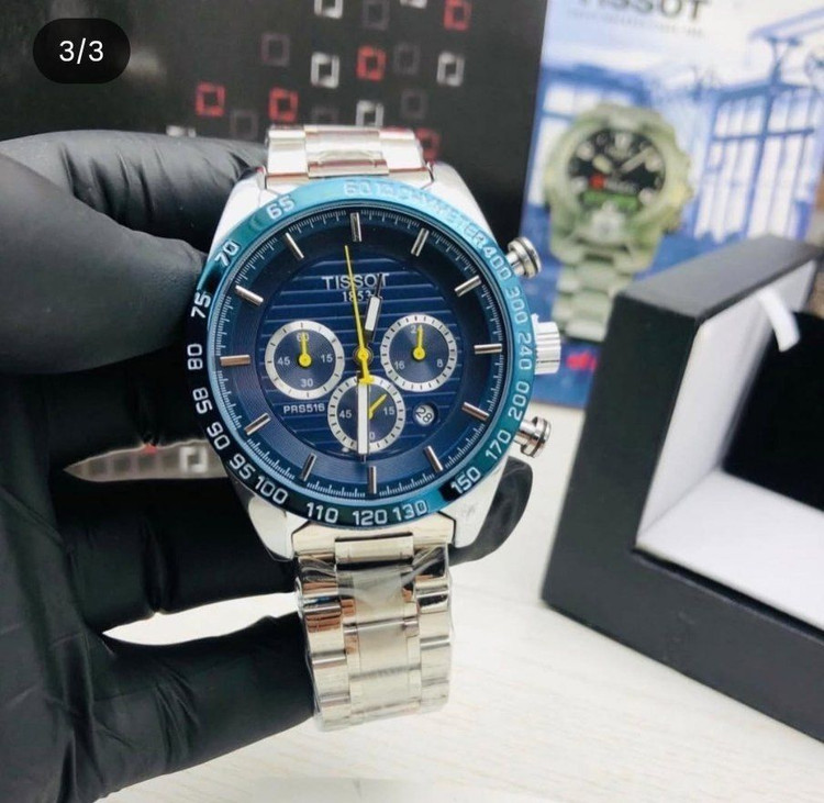 TISSOT prs516 سه موتور کرنوگراف موتور ژاپن دارای روز شمار قفل استیل پروانه ای (مخفی) بند استیل رنگ ثابت موتورکوارتز کرنو ضدآب قاب طلایی کرنوگراف